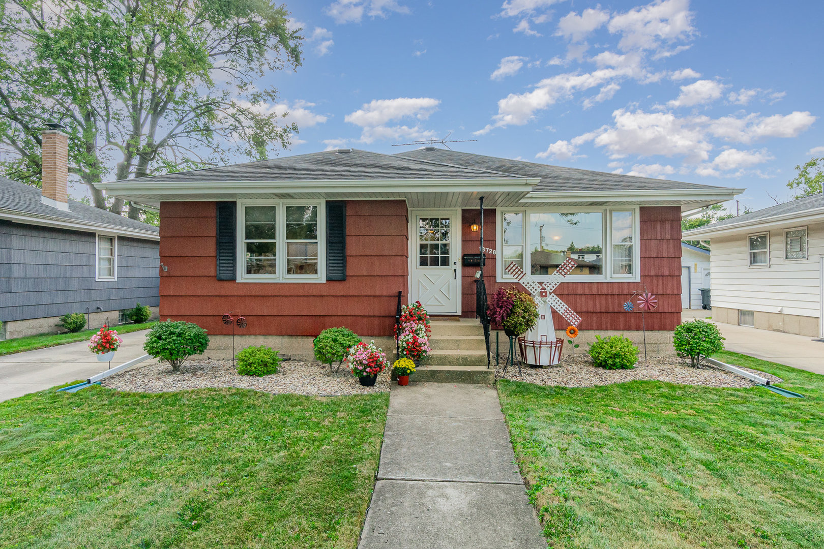 a front view of a house with garden