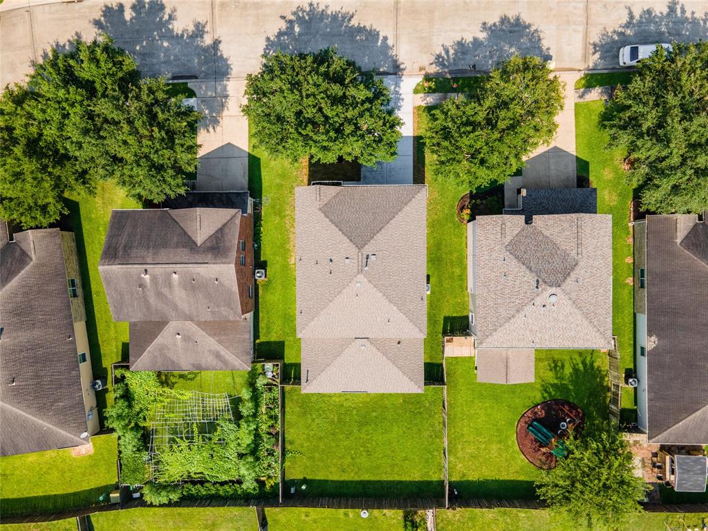 an aerial view of a house with a yard and garden