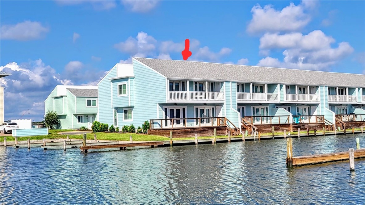 a front view of house with yard space and boats