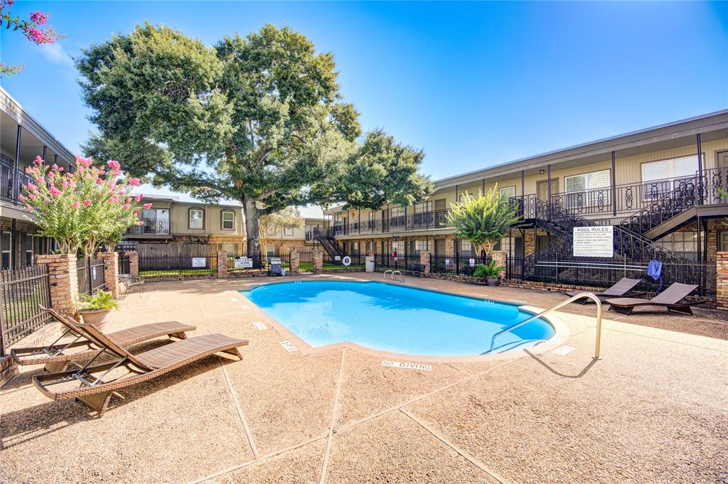 a view of a house with swimming pool and sitting area