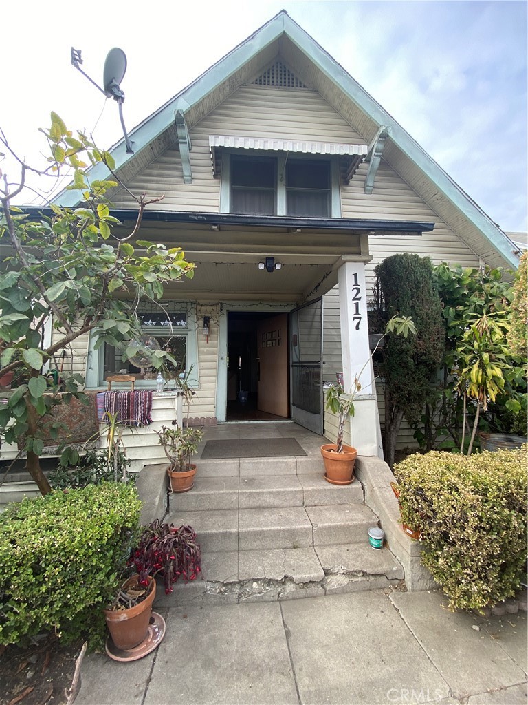 a view of a house with potted plants