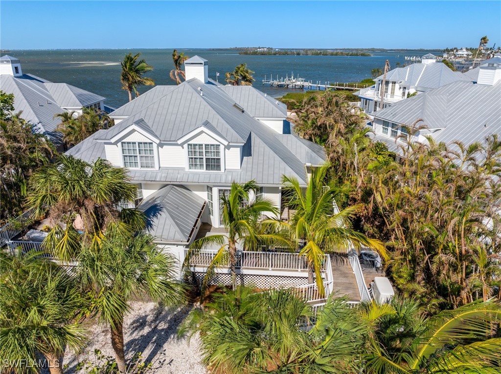 an aerial view of a house with a garden and lake view