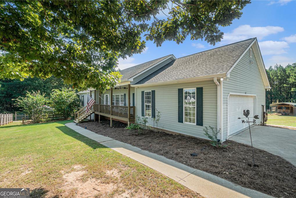 a view of a house with a yard and sitting area