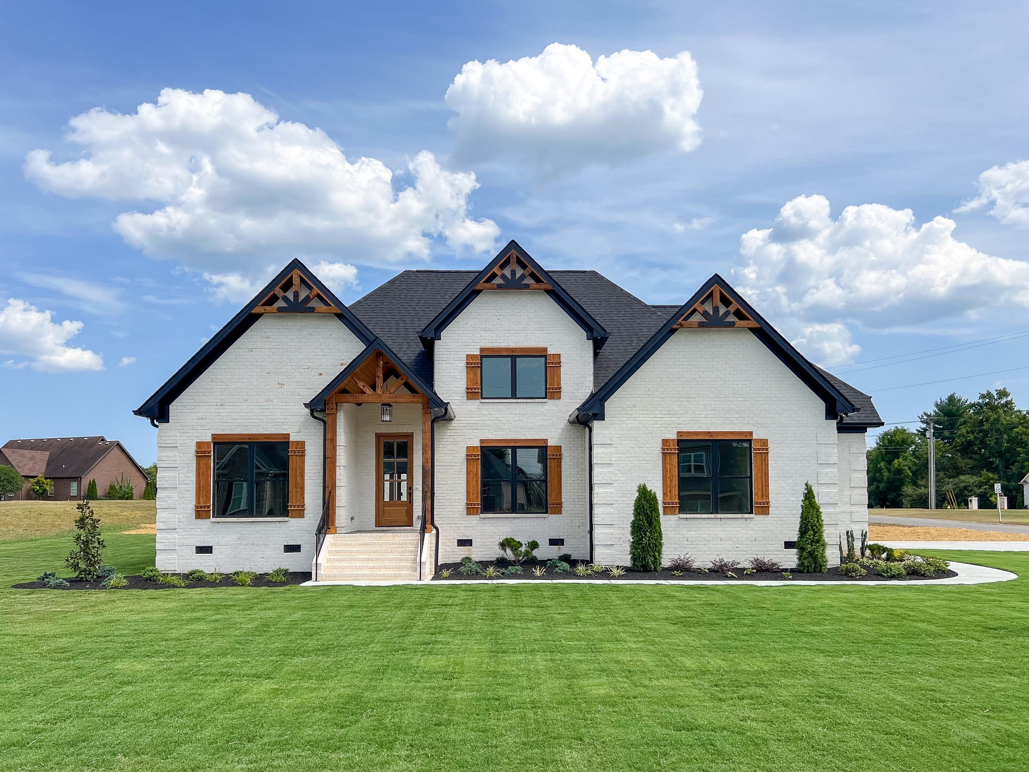 a front view of a house with a garden