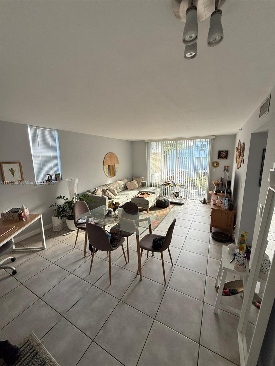 a living room with furniture a rug and a flat screen tv