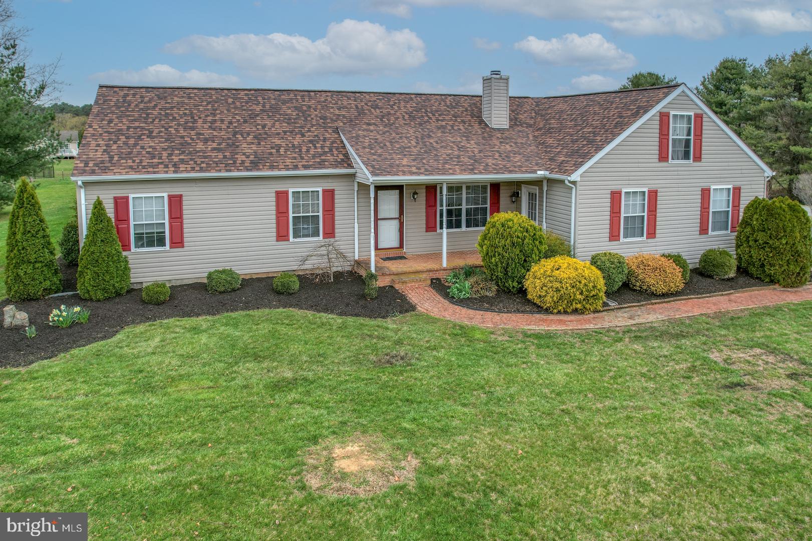 a front view of a house with a garden and porch