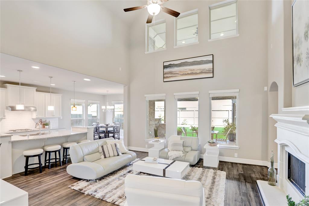 Large windows to outdoor covered patio and upper windows to covered balcony.