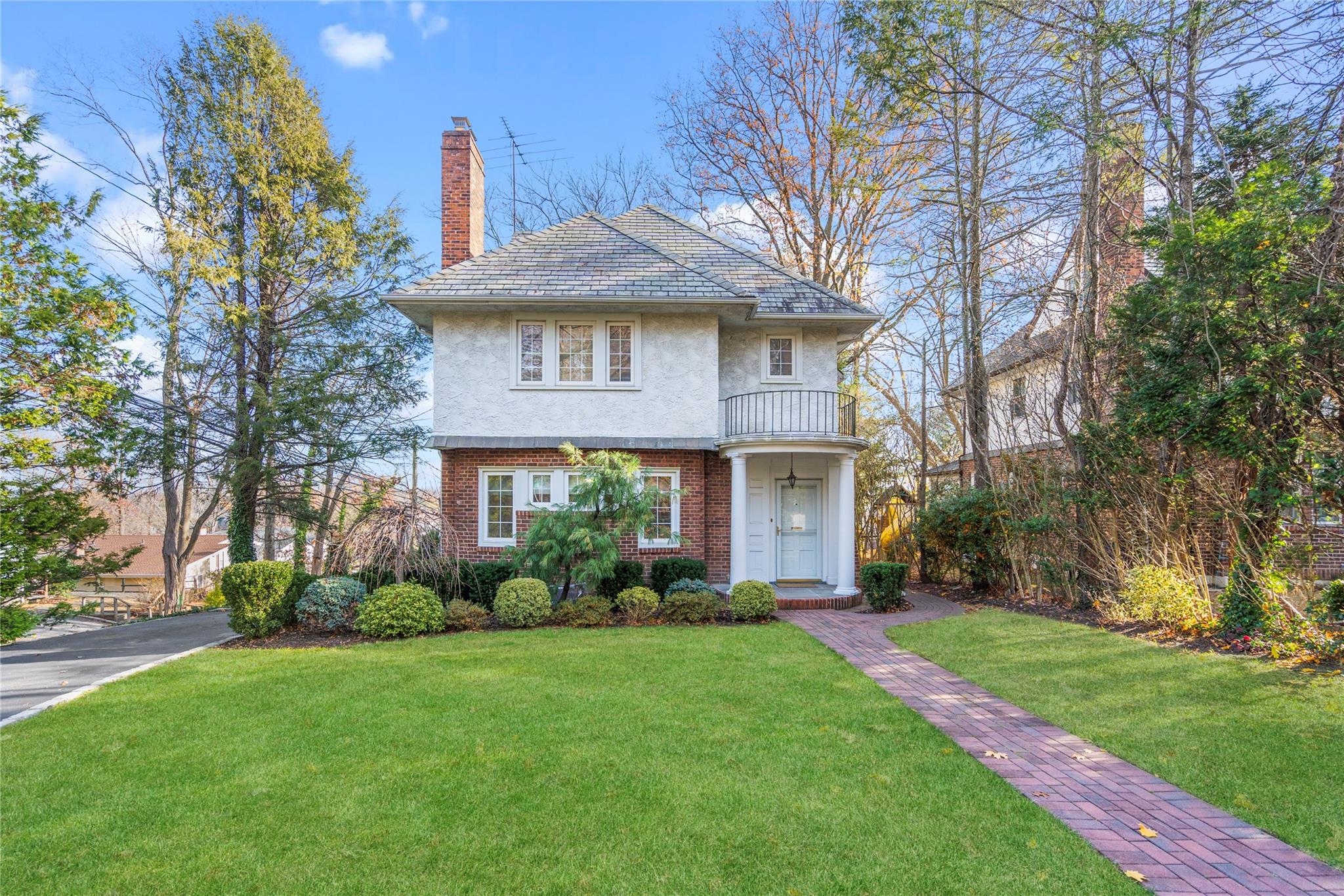 a front view of a house with garden