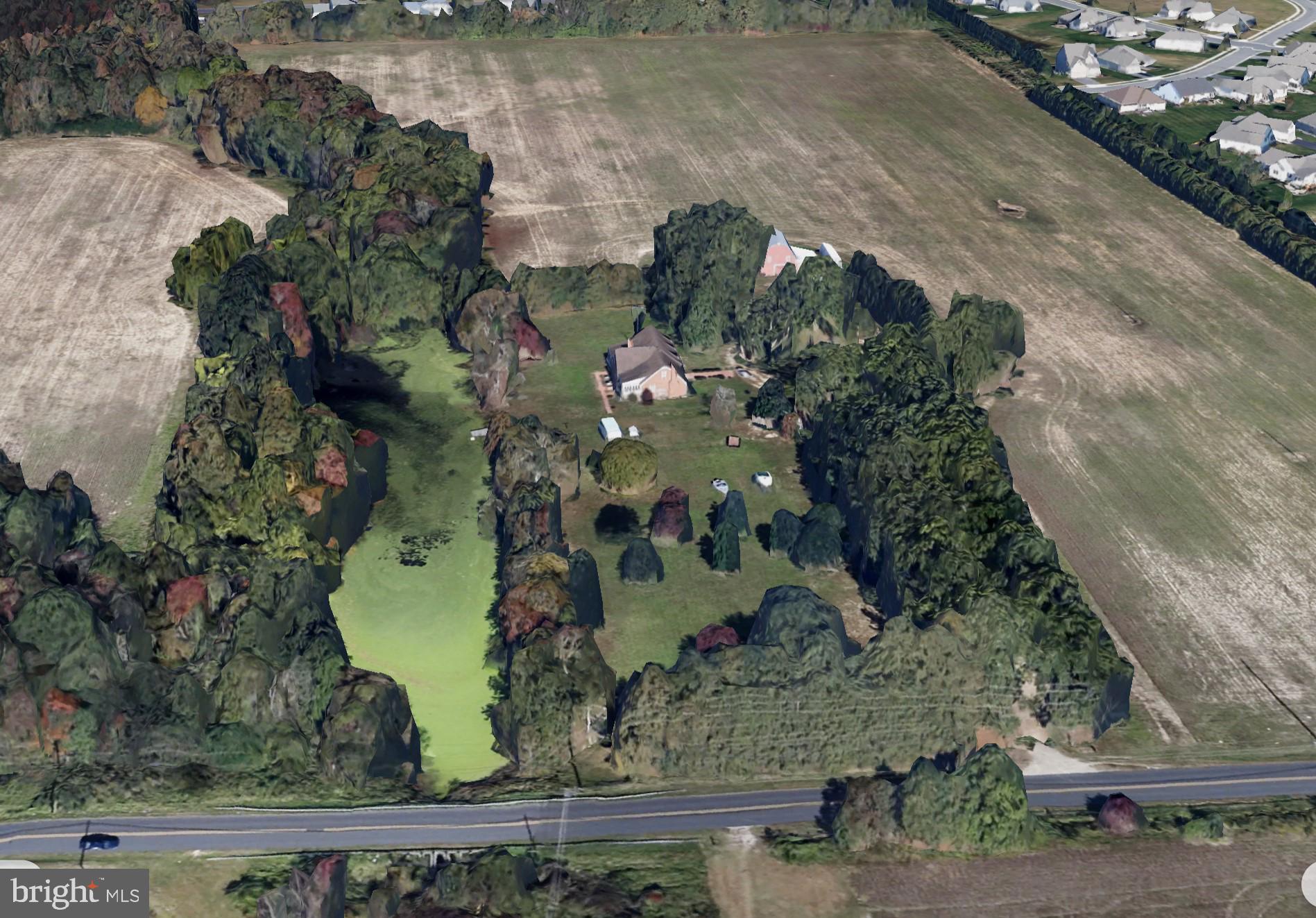 an aerial view of a residential houses with outdoor space