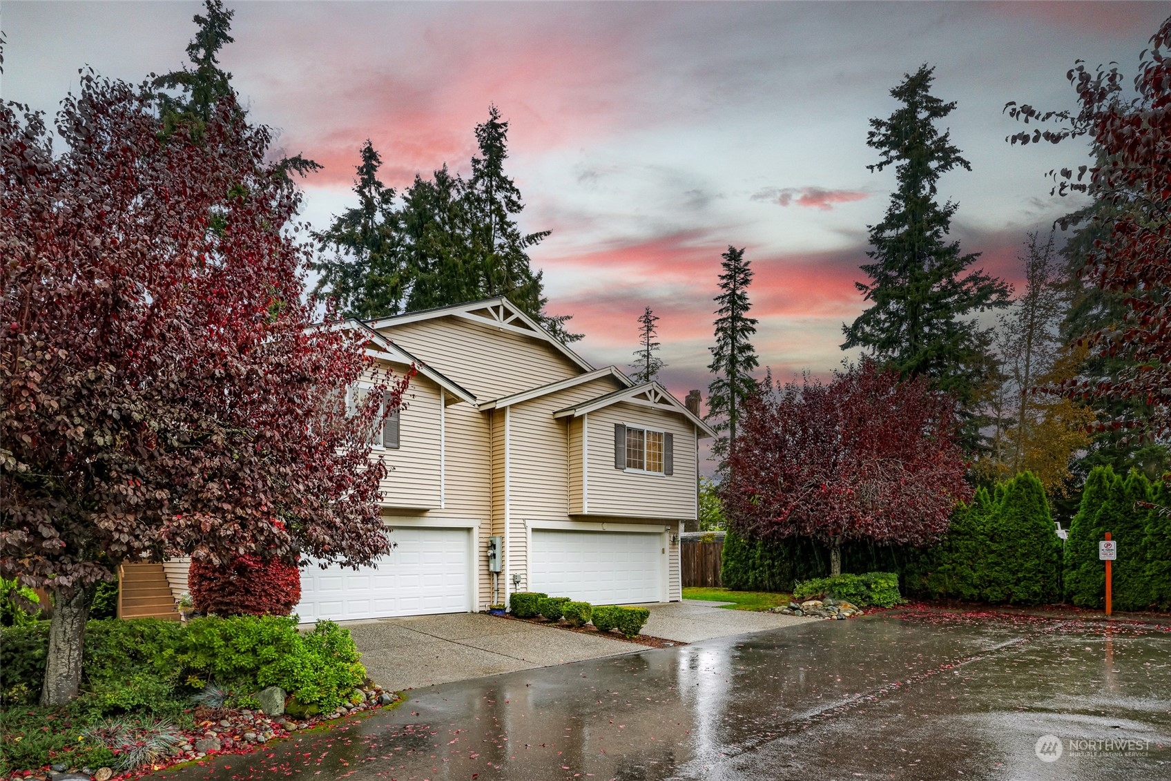 a front view of a house with a yard and trees