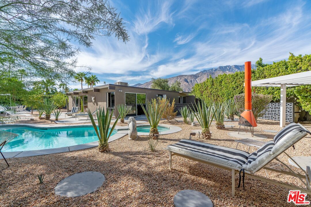 a view of a backyard with sitting area