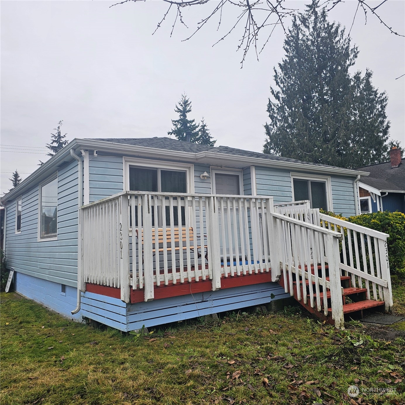 a view of a house with a yard and deck