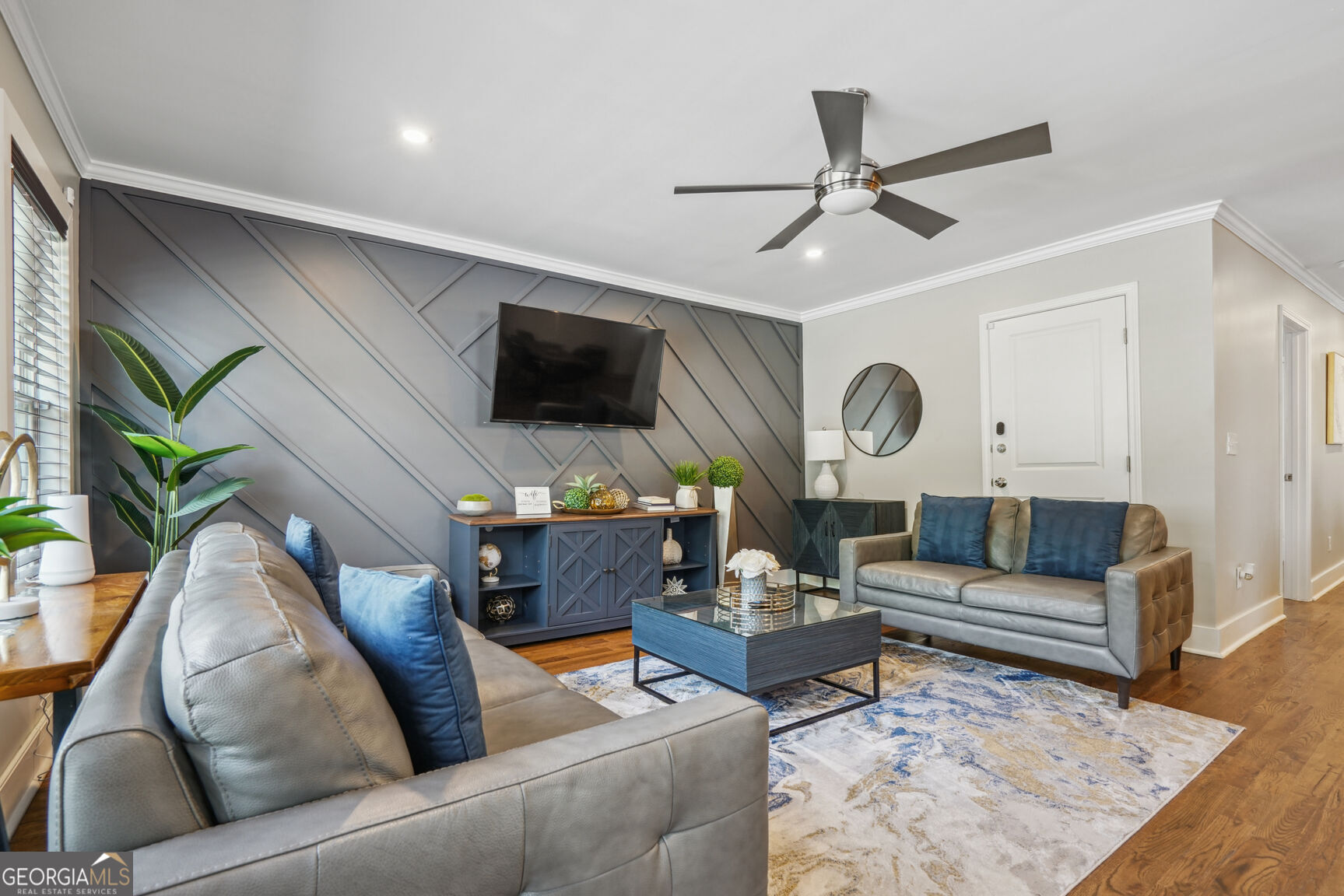 a living room with furniture and a flat screen tv