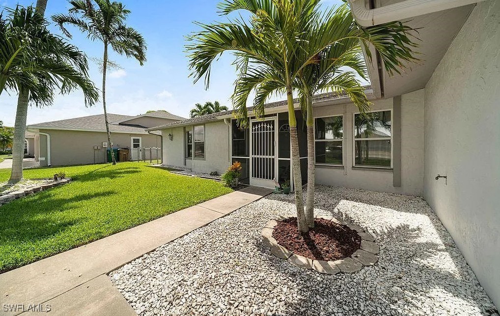 a front view of a house with garden