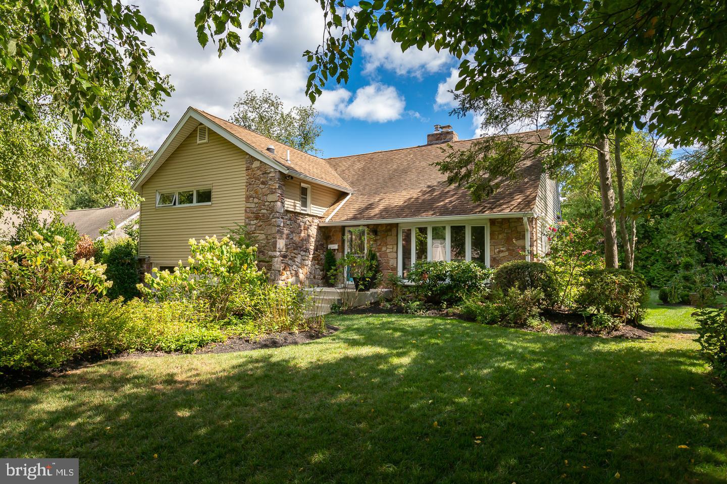 a front view of house with a garden