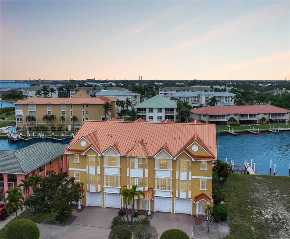 an aerial view of a house with swimming pool and lake view