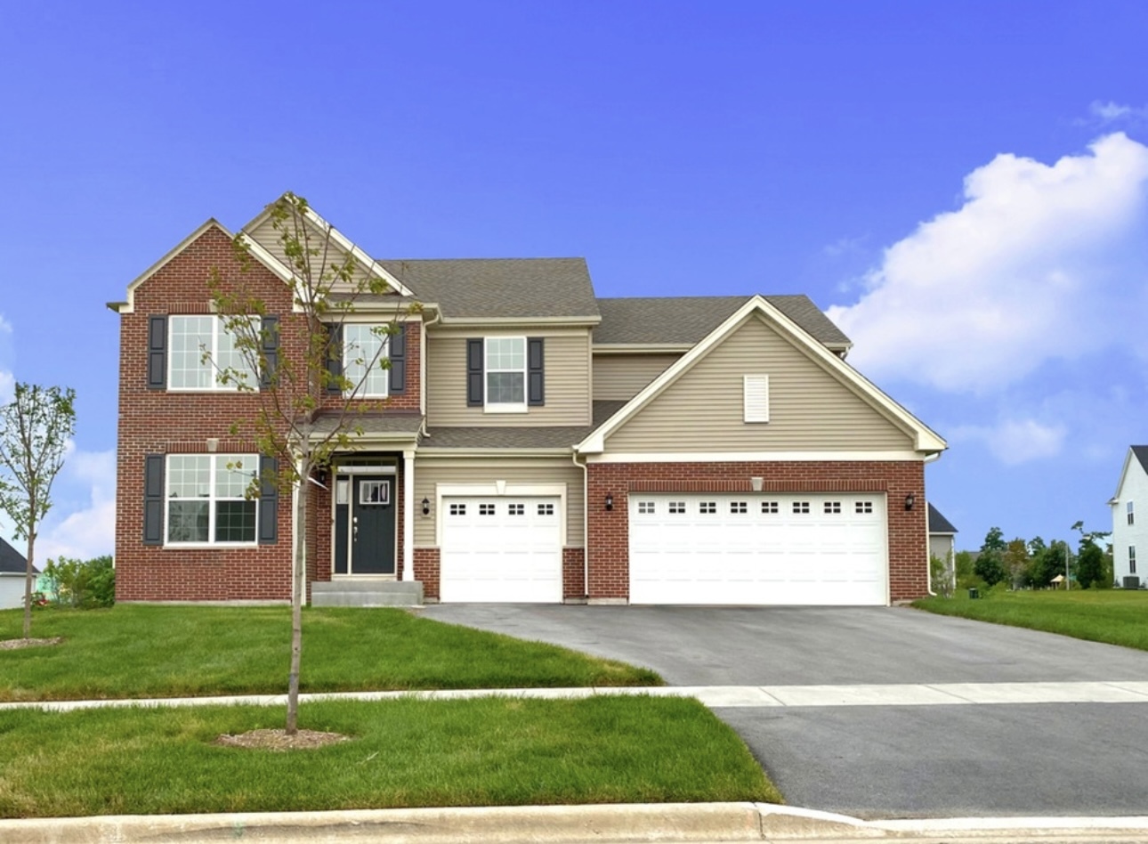 a view of a big house with a yard and large tree