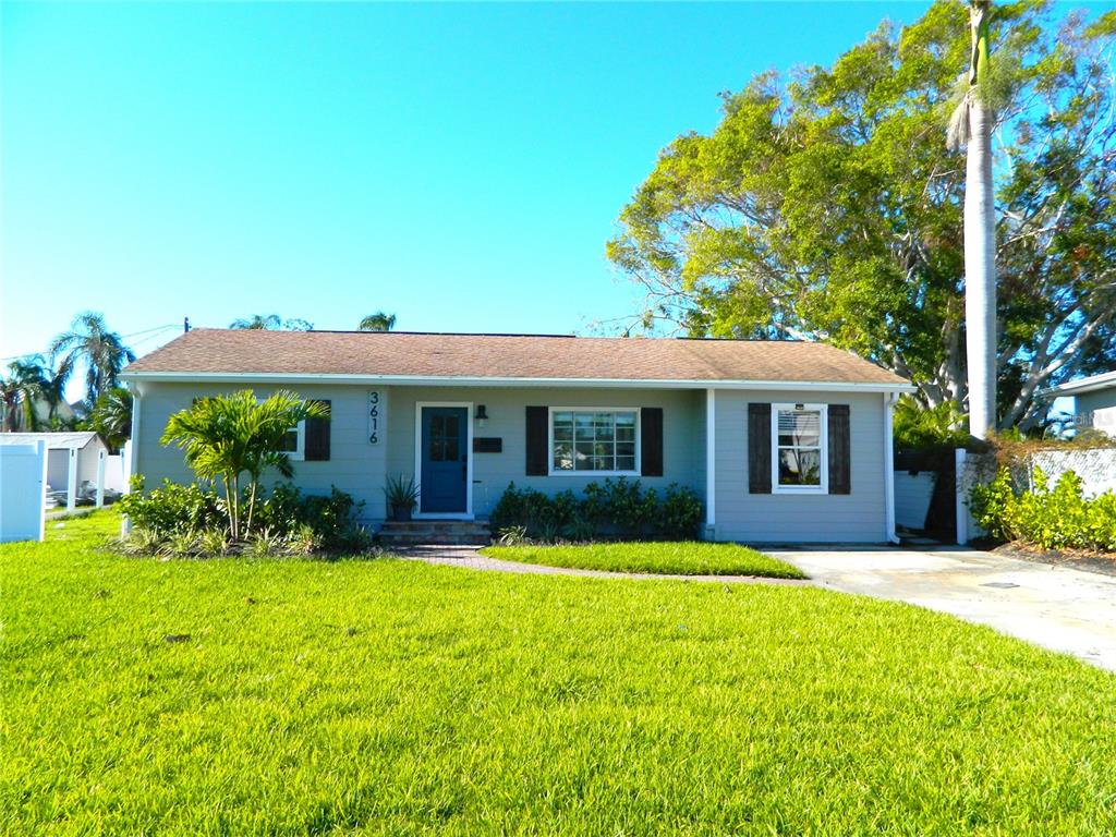 a front view of house with yard and green space