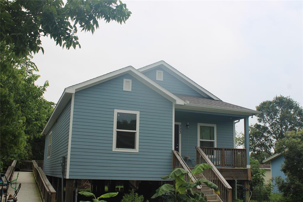 a front view of a house with plants