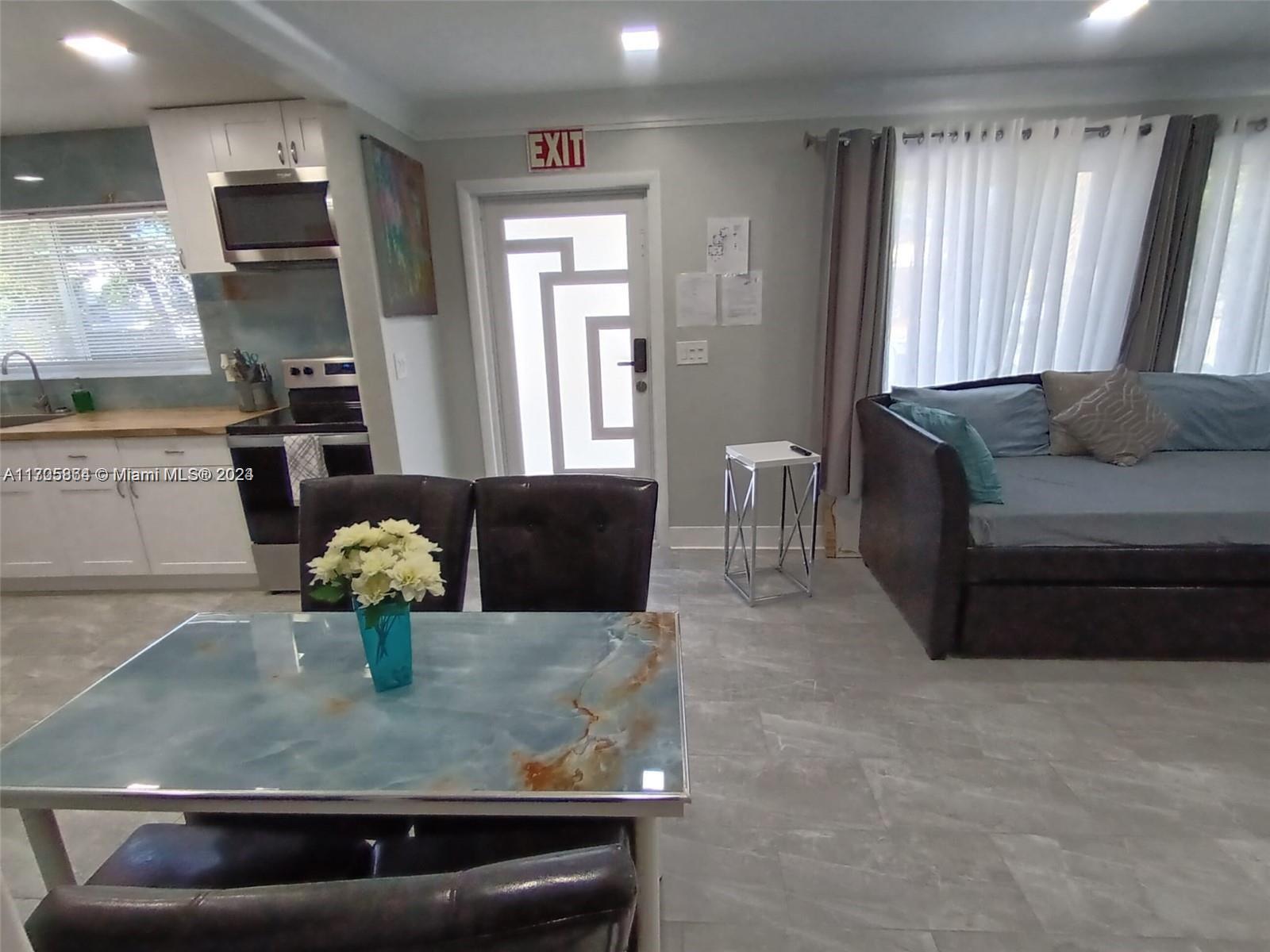 a living room with kitchen island furniture and a window