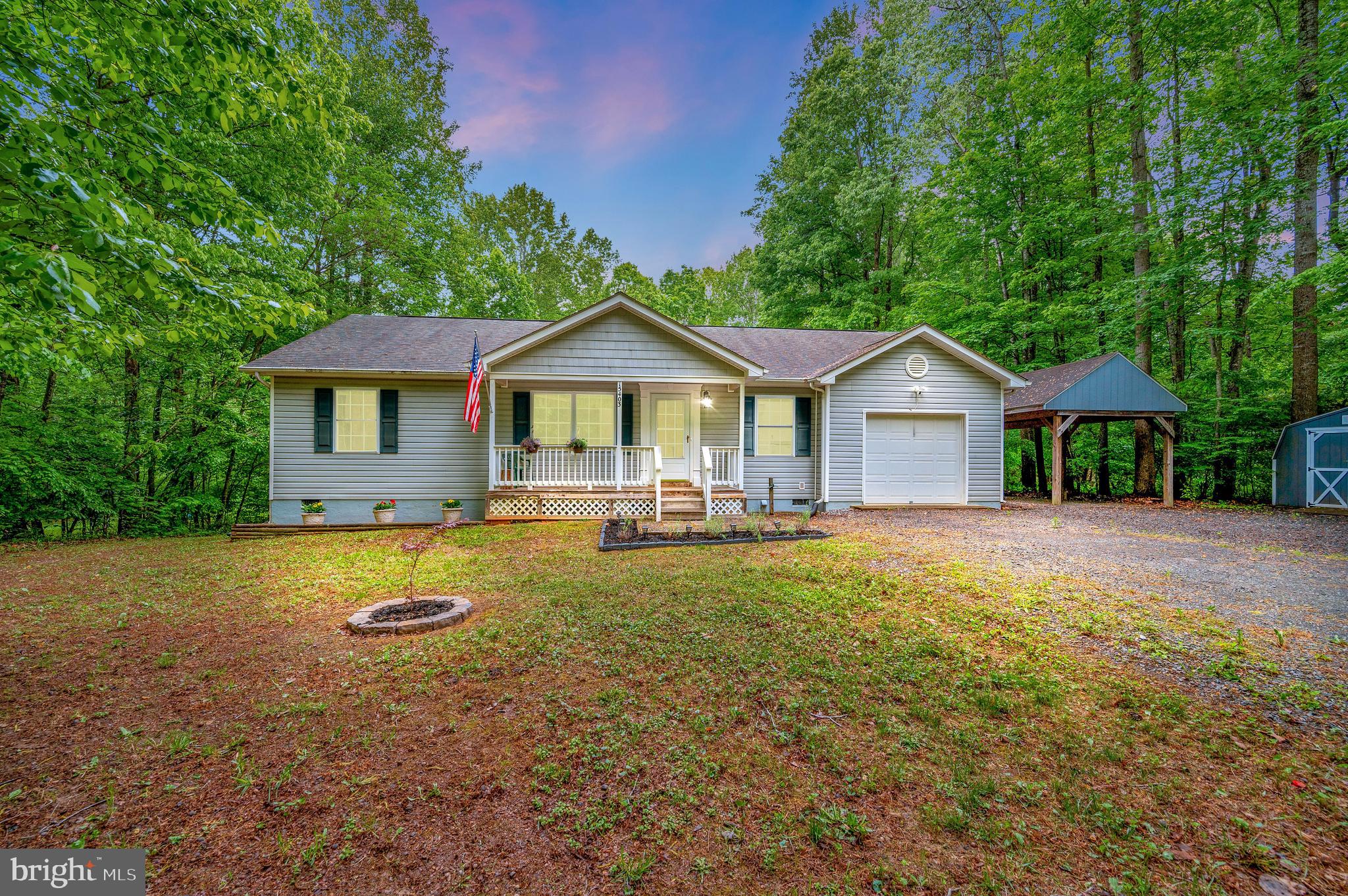 a front view of a house with yard and green space