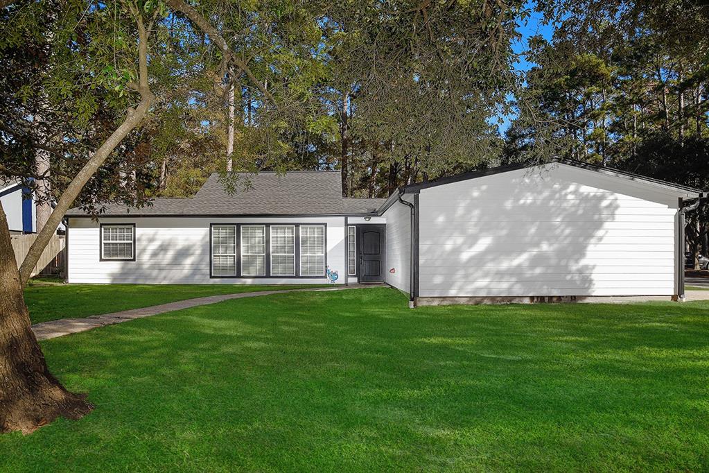 a view of a house with a backyard