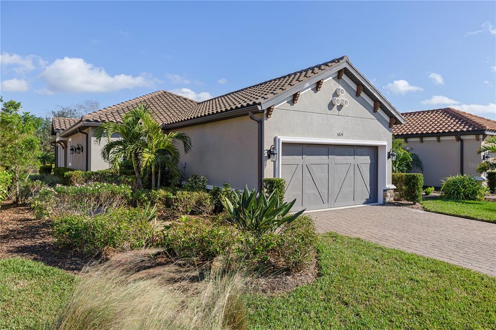 a front view of a house with a yard and garage