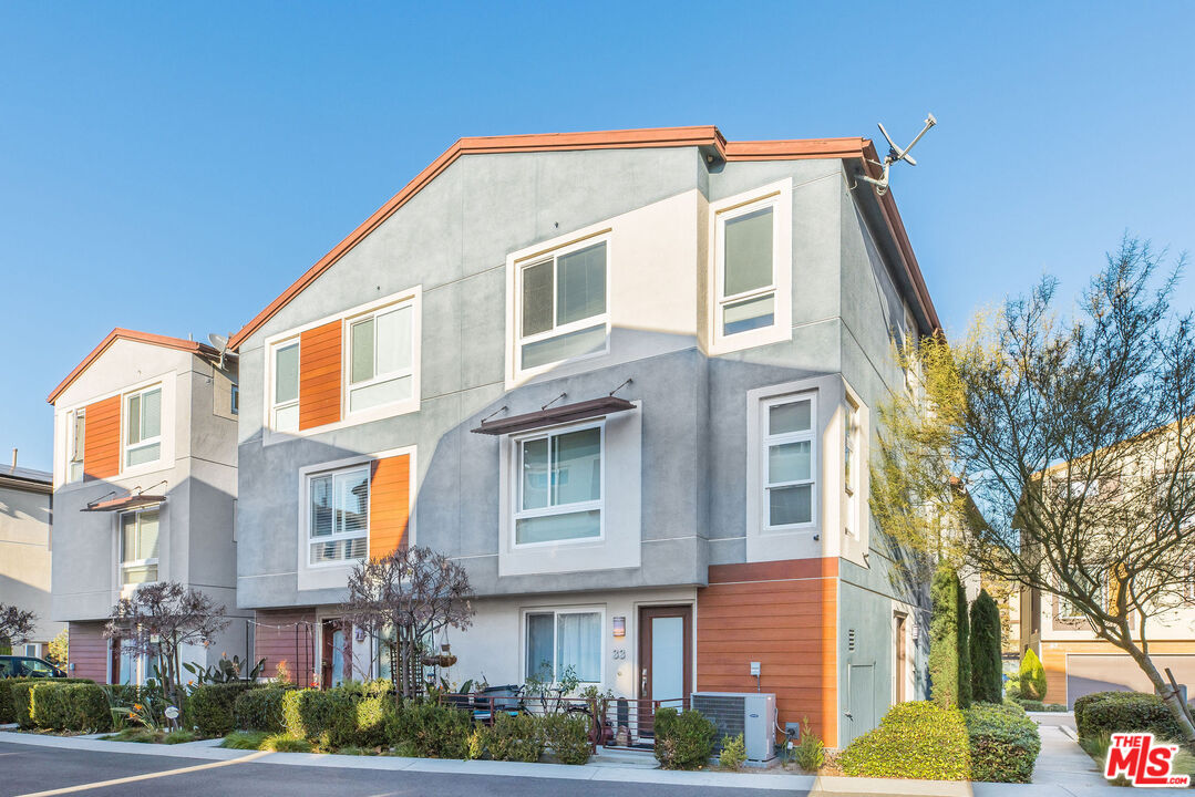 a front view of a residential apartment building with a yard