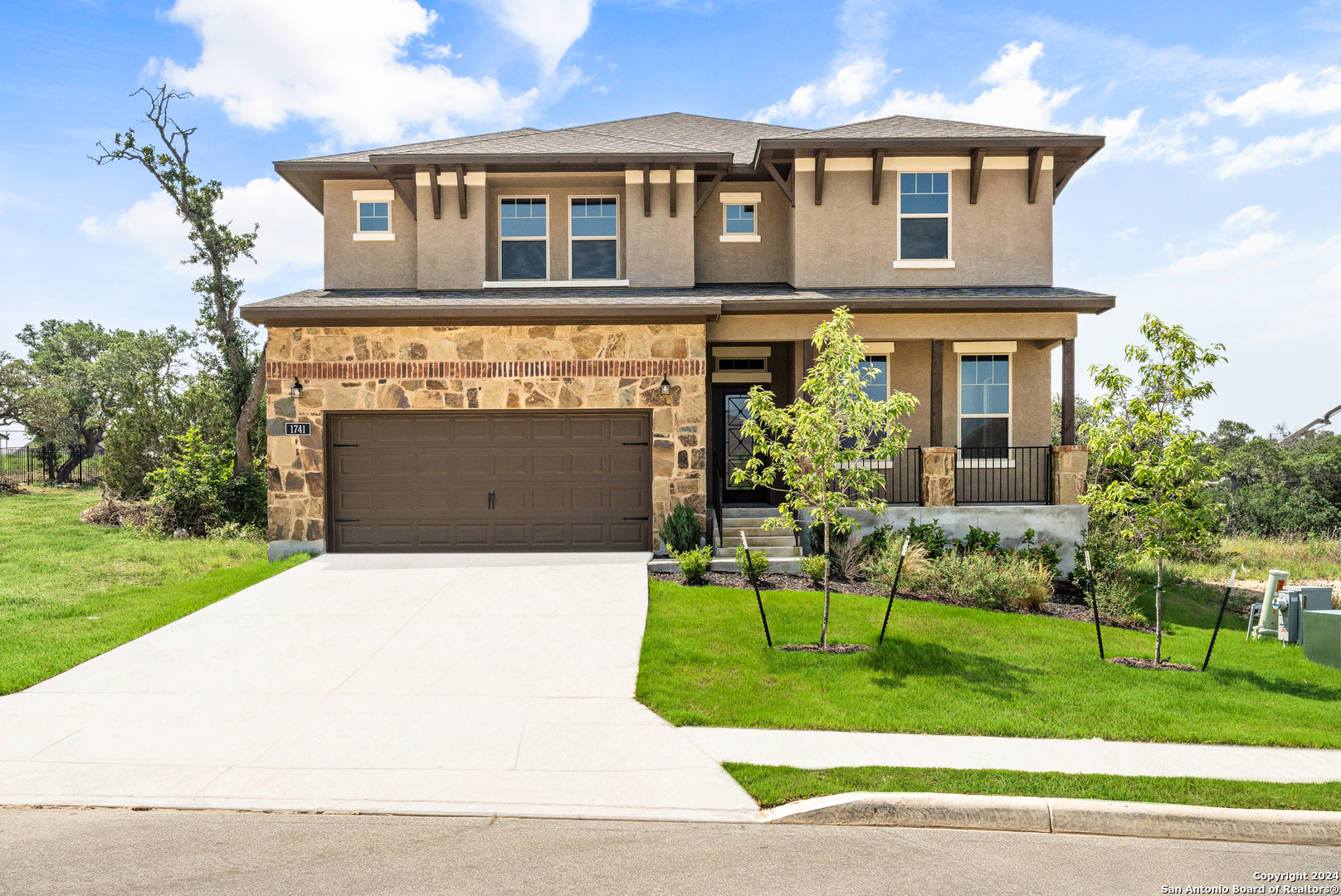 a front view of a house with a garden