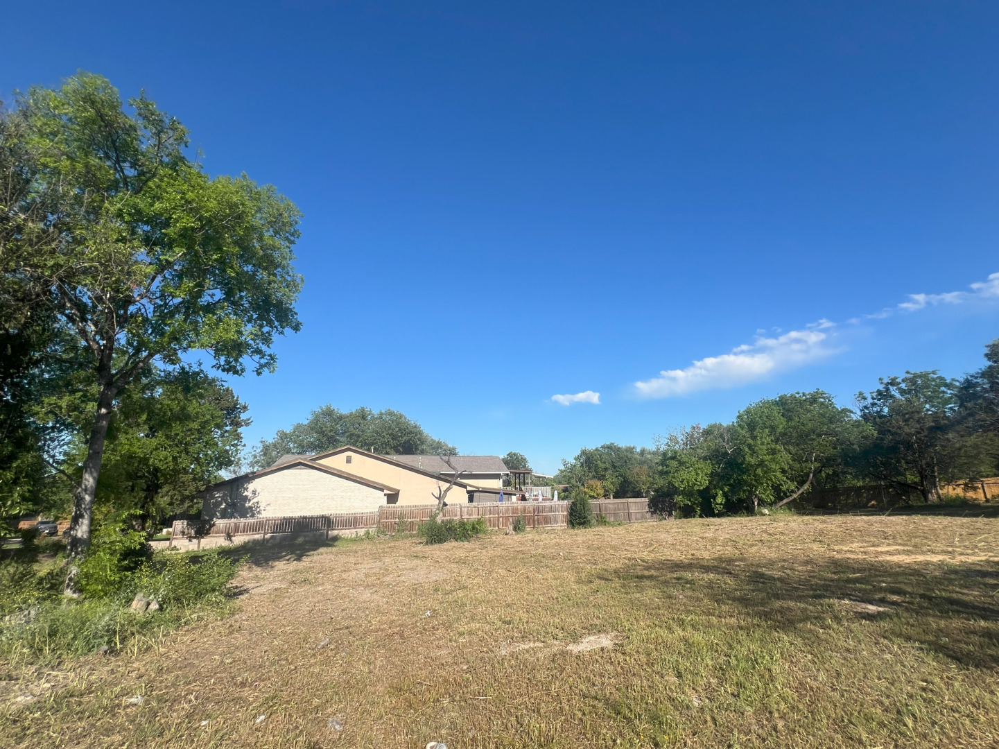 a view of a house with a yard and street view