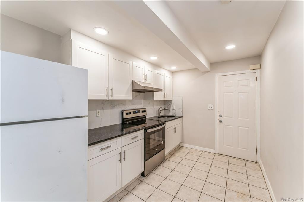 a kitchen with stainless steel appliances a refrigerator sink and cabinets