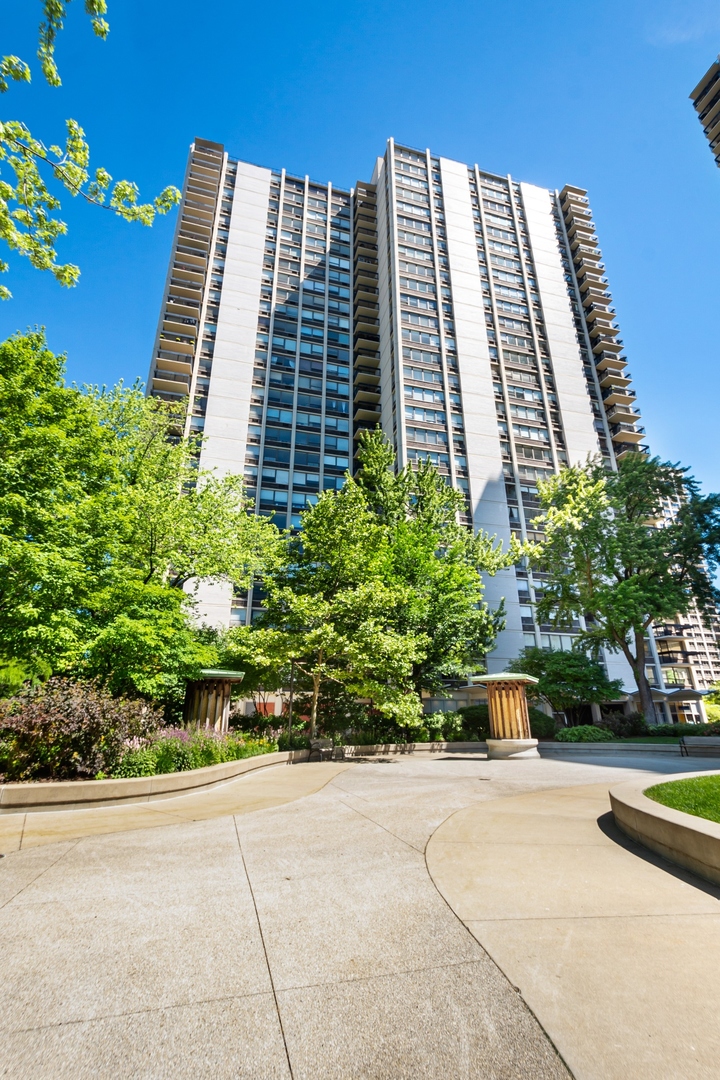 a front view of a residential apartment building with a yard