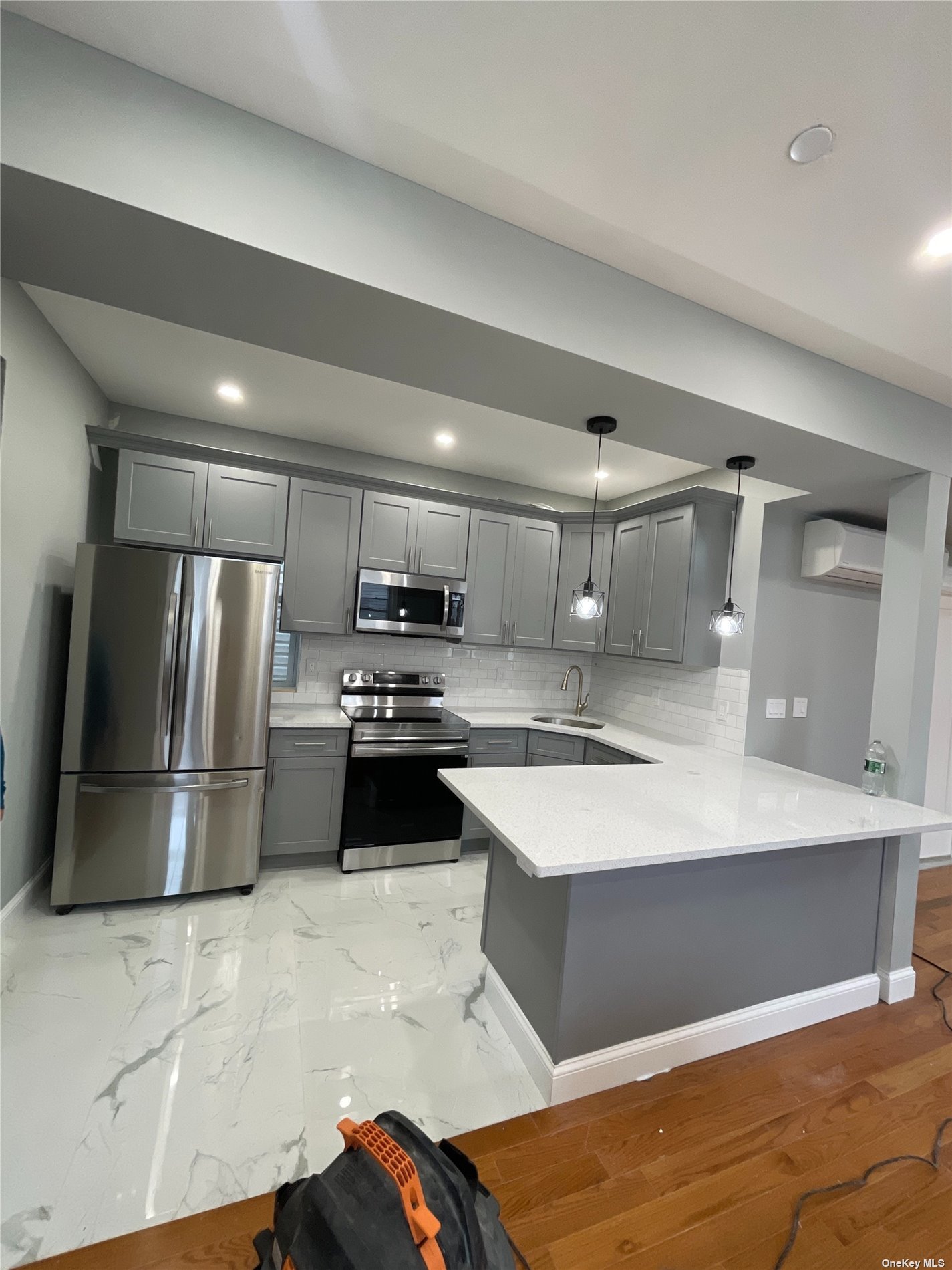 a large kitchen with a large counter top stainless steel appliances and cabinets