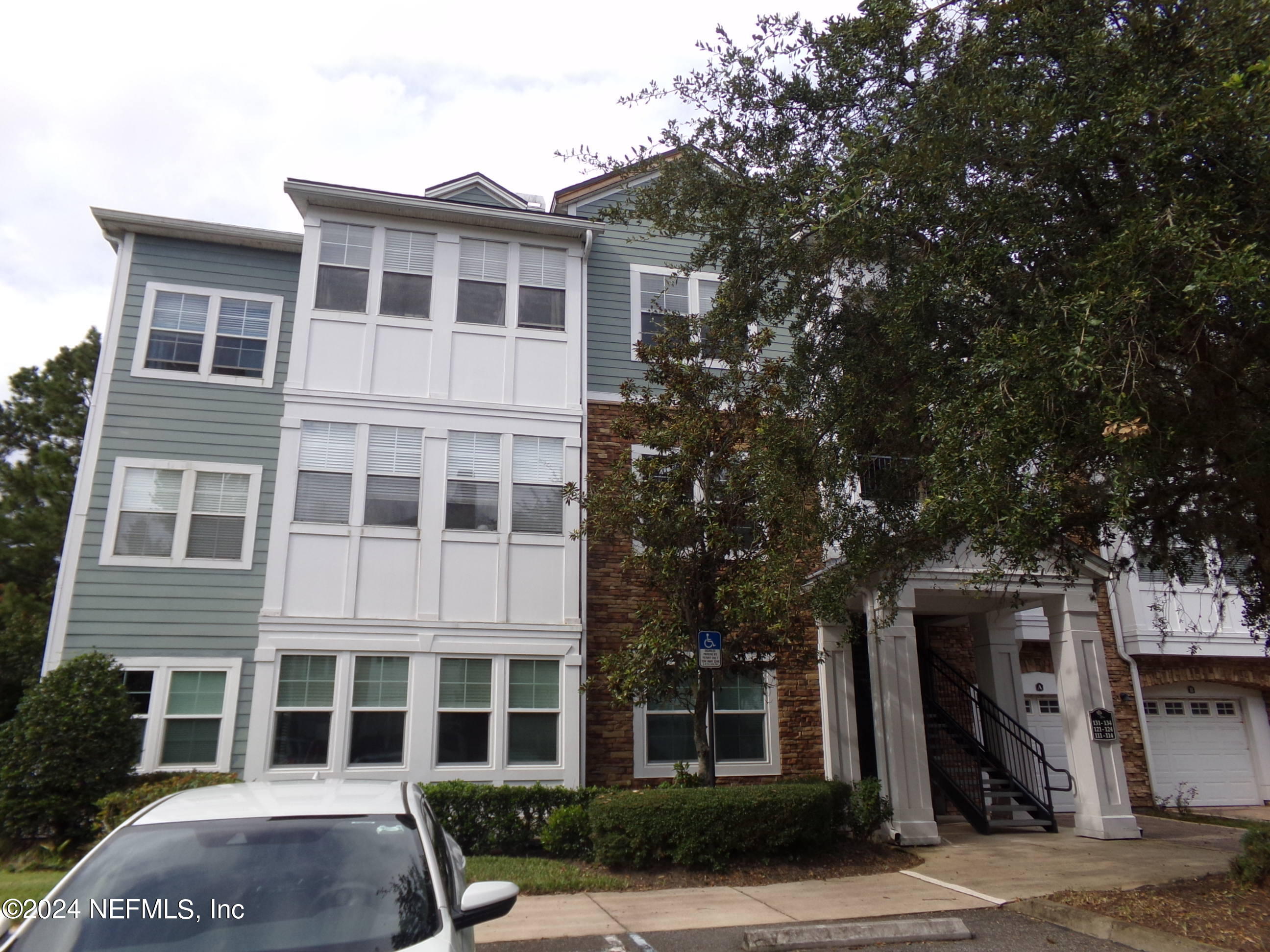 a front view of a building with a yard