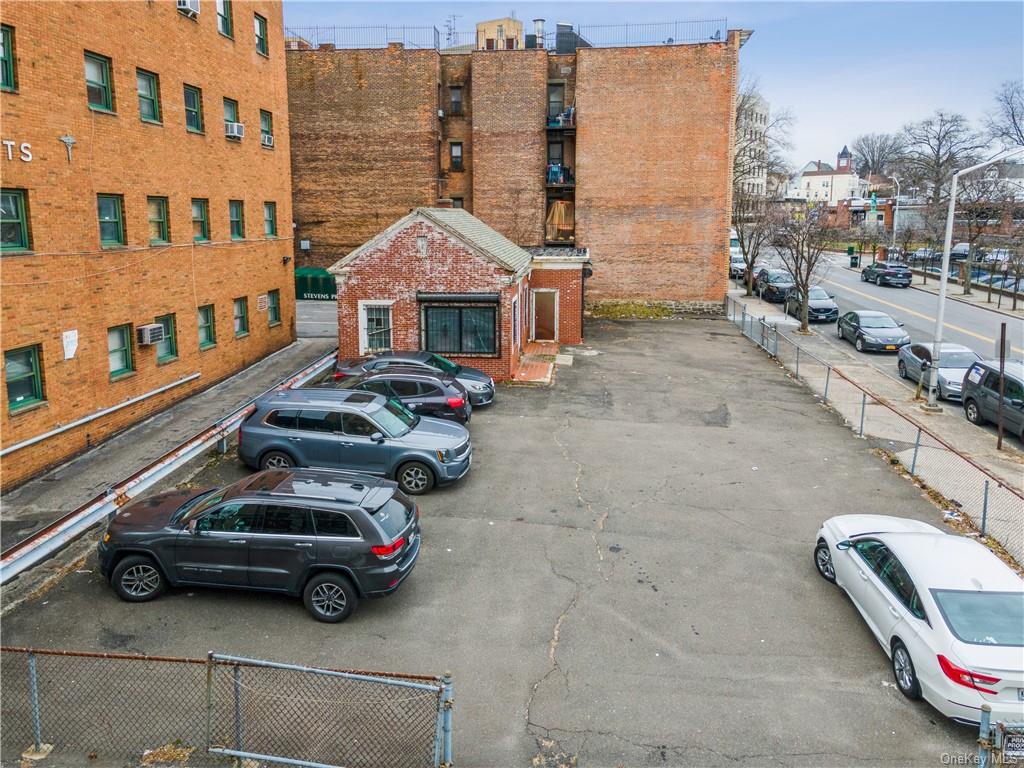 a view of a car is parked in front of a brick building