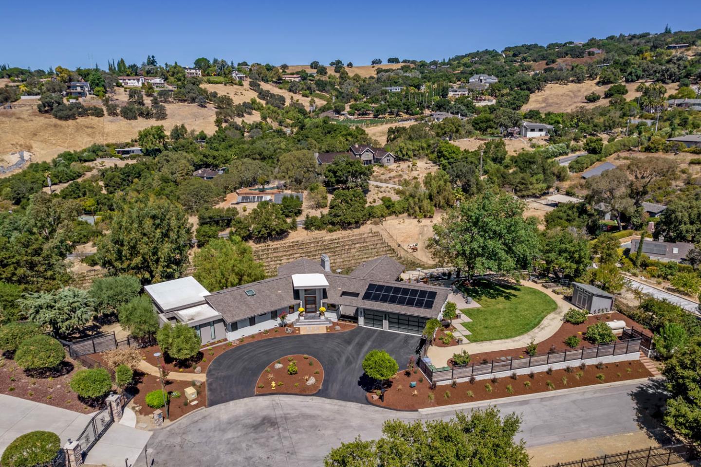 an aerial view of a house with a yard