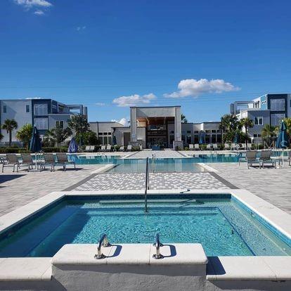 a swimming pool with outdoor seating and yard