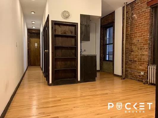 a view of a hallway with wooden door