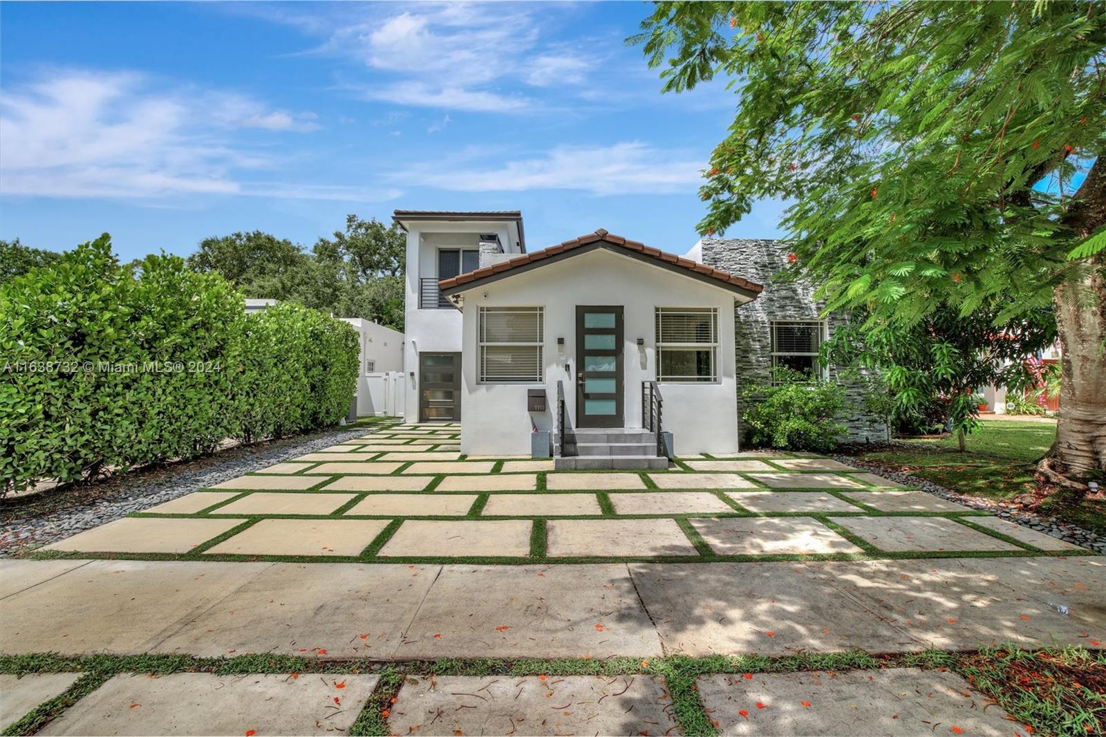 a front view of a house with a garden