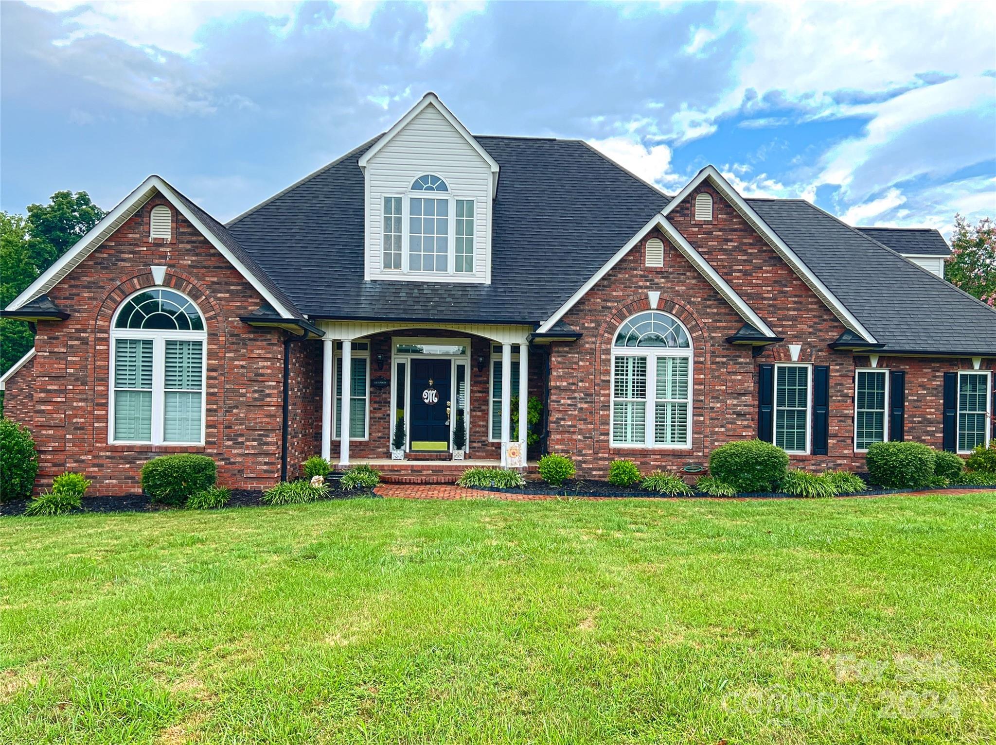 a front view of a house with a yard