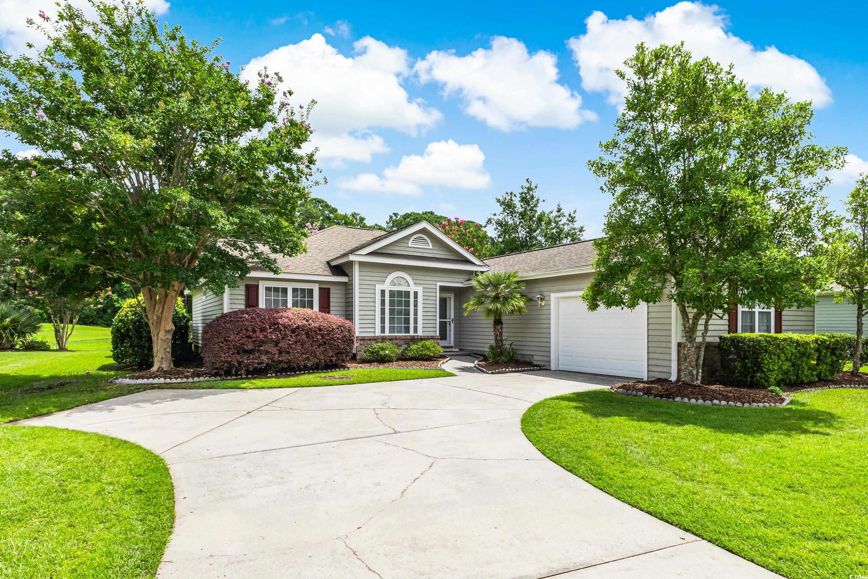 Single story home featuring a garage and a front l