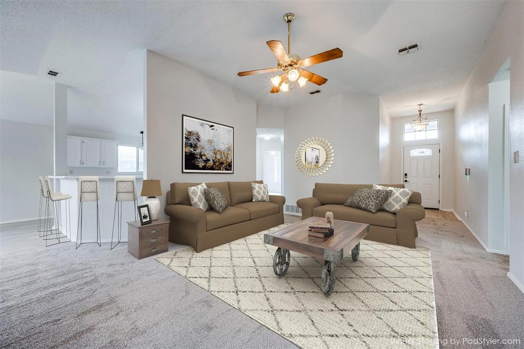 a living room with furniture and a chandelier