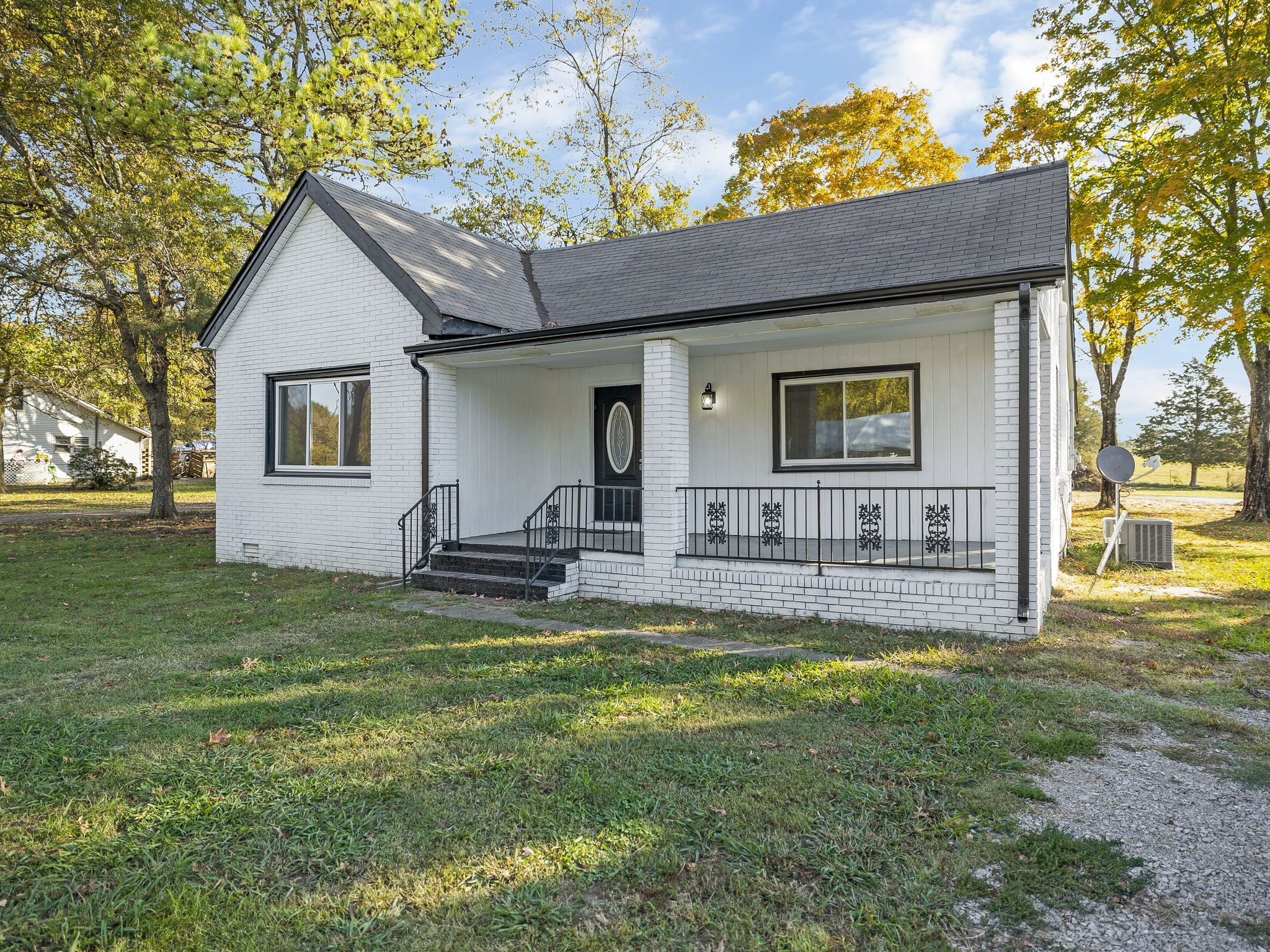 a view of a house with a yard and a patio