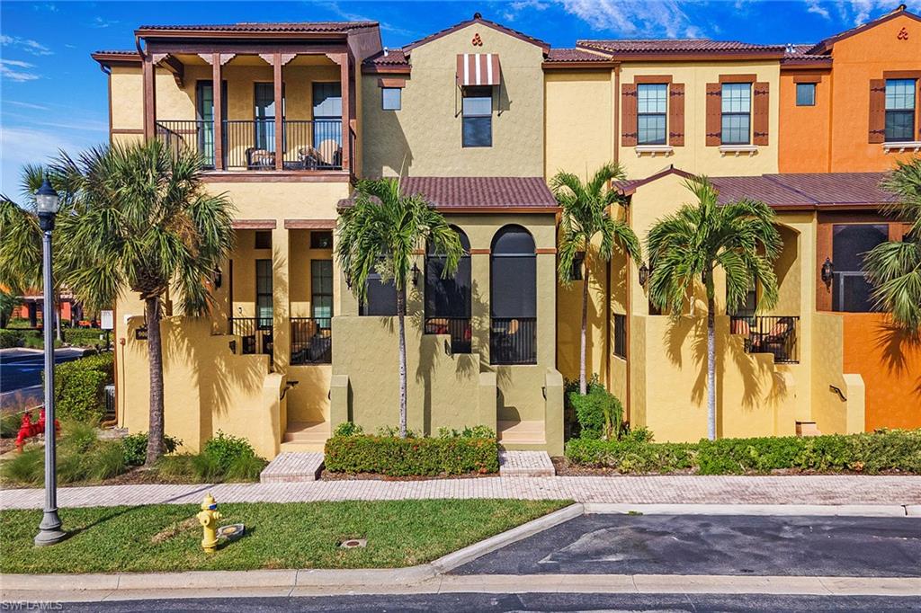 a front view of a residential apartment building with a yard