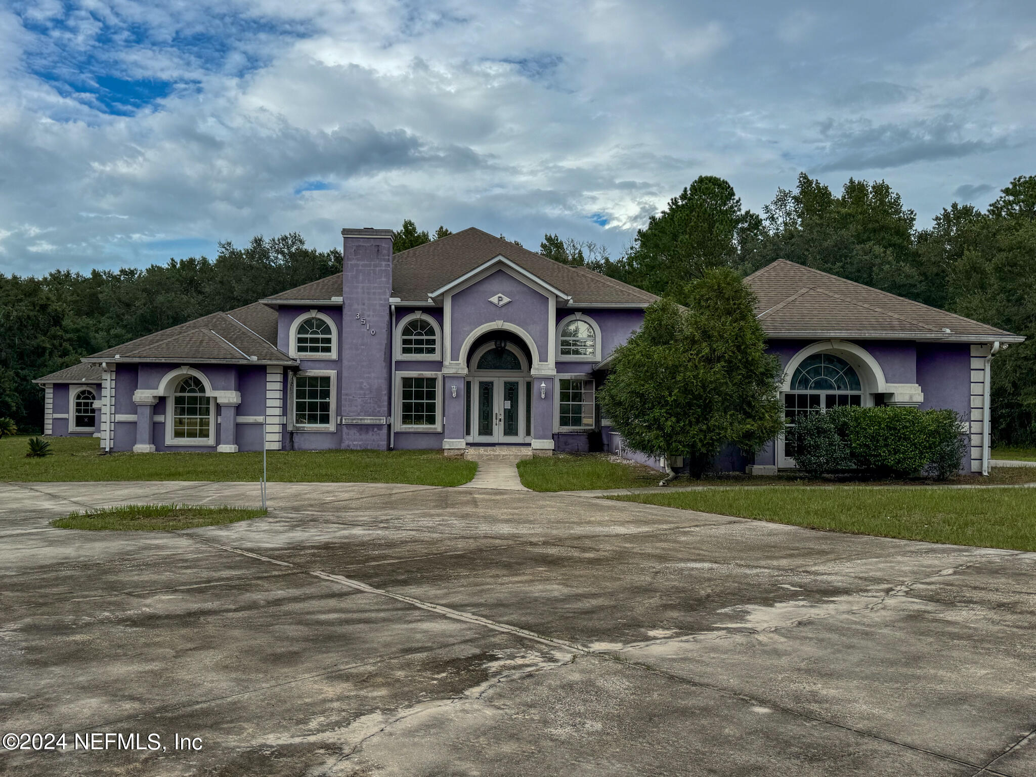 a front view of a house with a garden