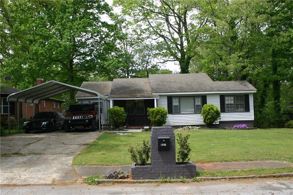 a front view of a house with a yard garden