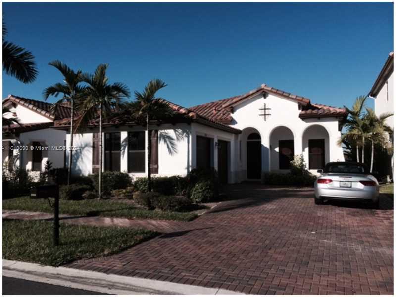 a front view of a house with yard and parking