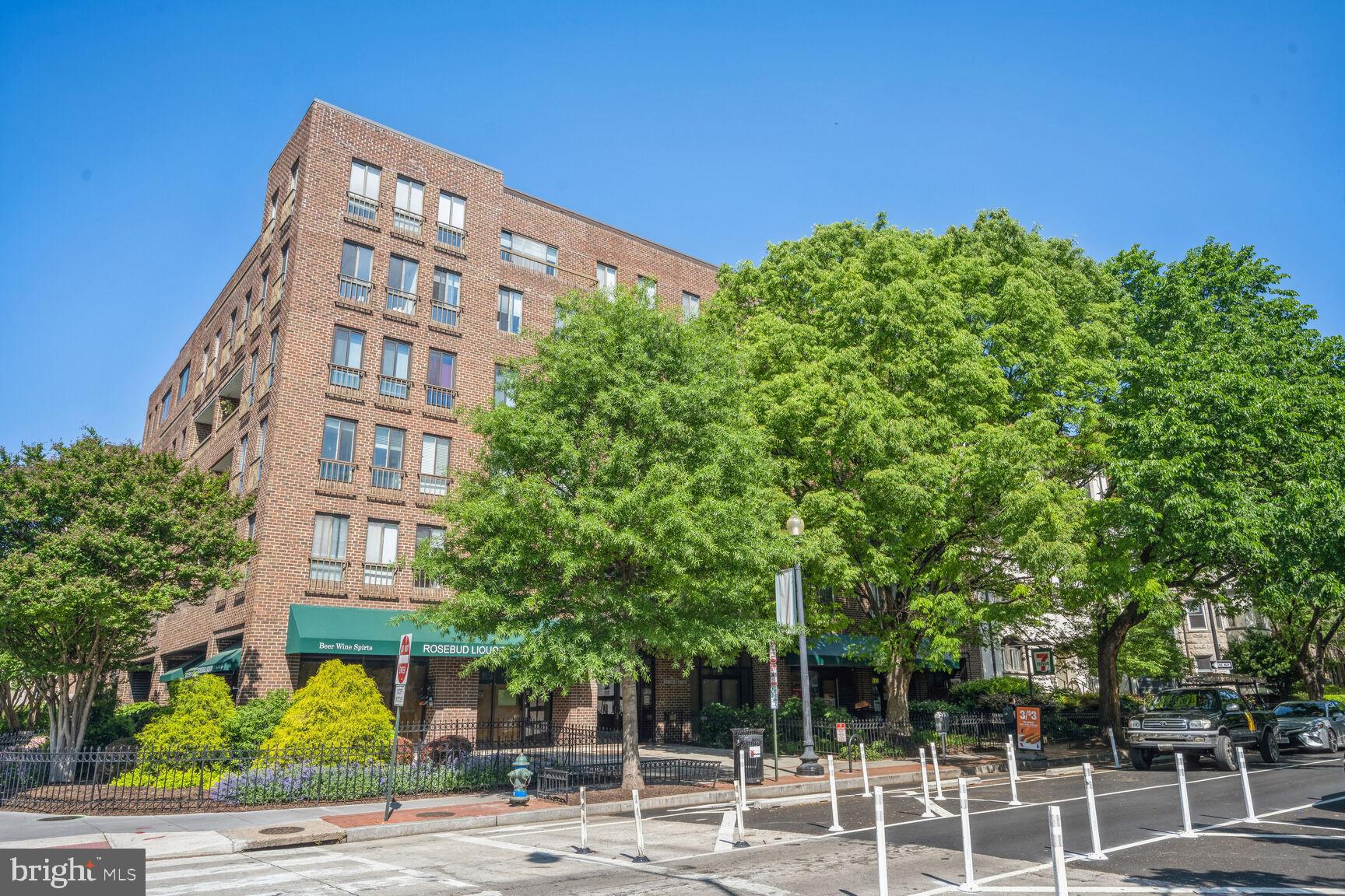 front view of a building with a tree