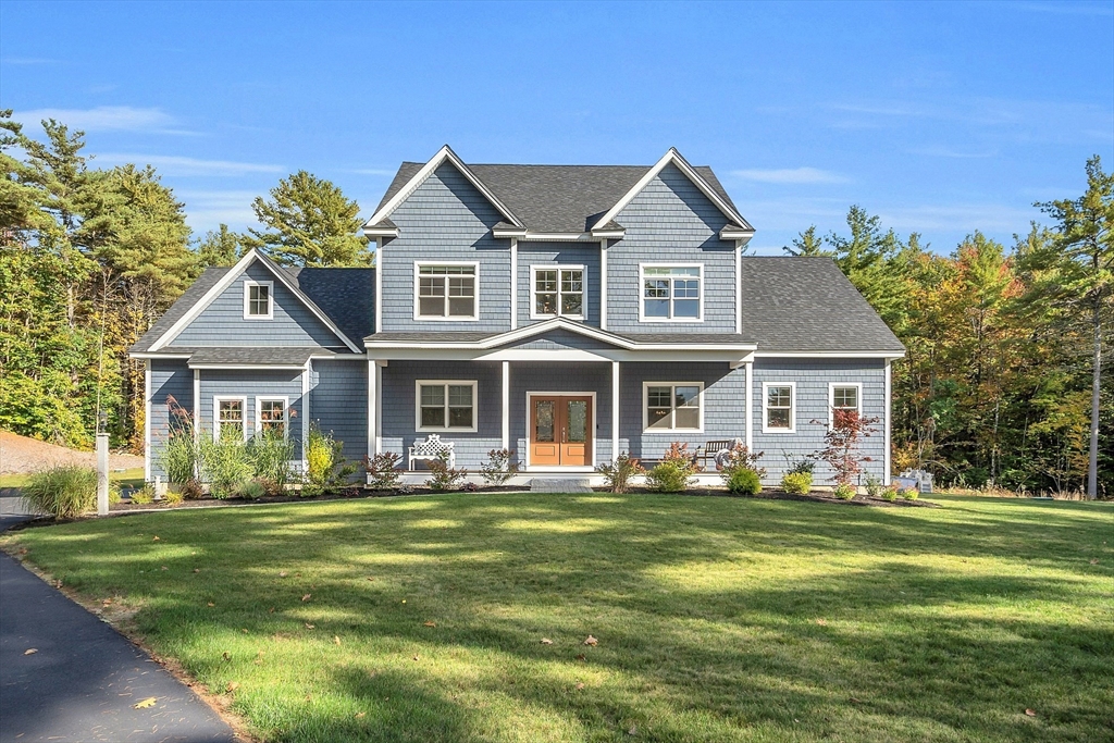 a front view of a house with a garden