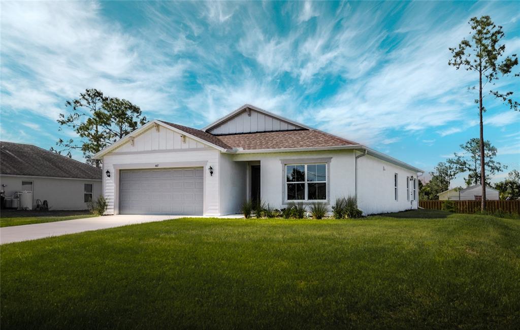 a front view of a house with a yard and garage